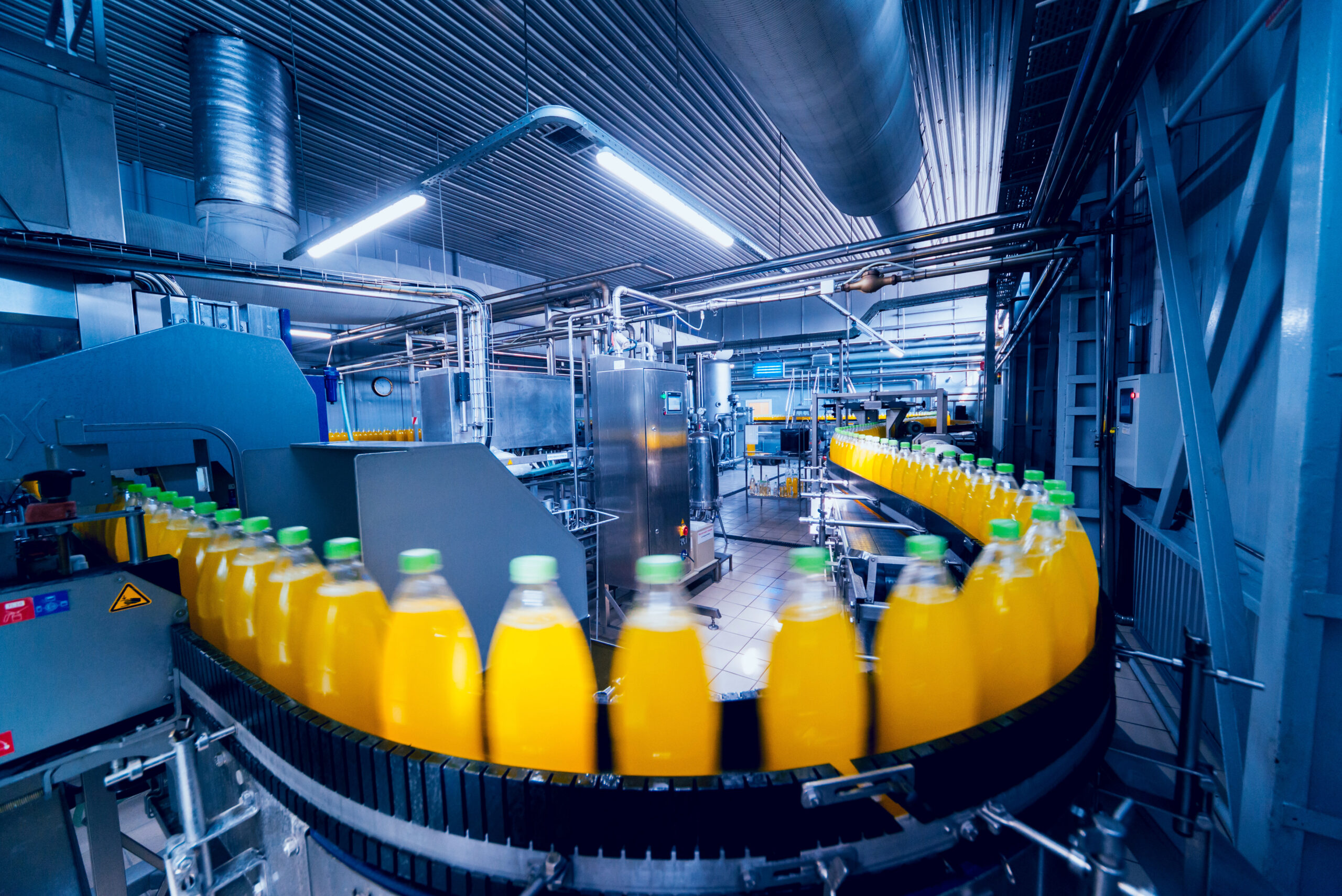 Beverage factory interior. Conveyor with bottles for juice or water. Equipments
